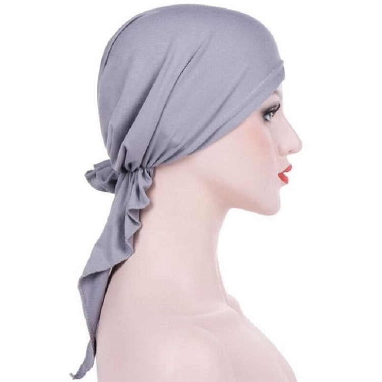 Light gray curved wrap cap turban hat with draped side tie and tied tail