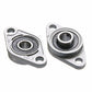 Two zinc alloy bearing housings with black inner bearings, angled view