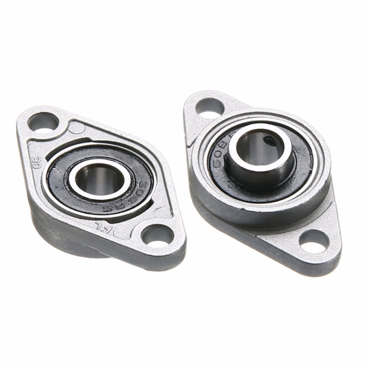 Two zinc alloy bearing housings with black inner bearings, angled view
