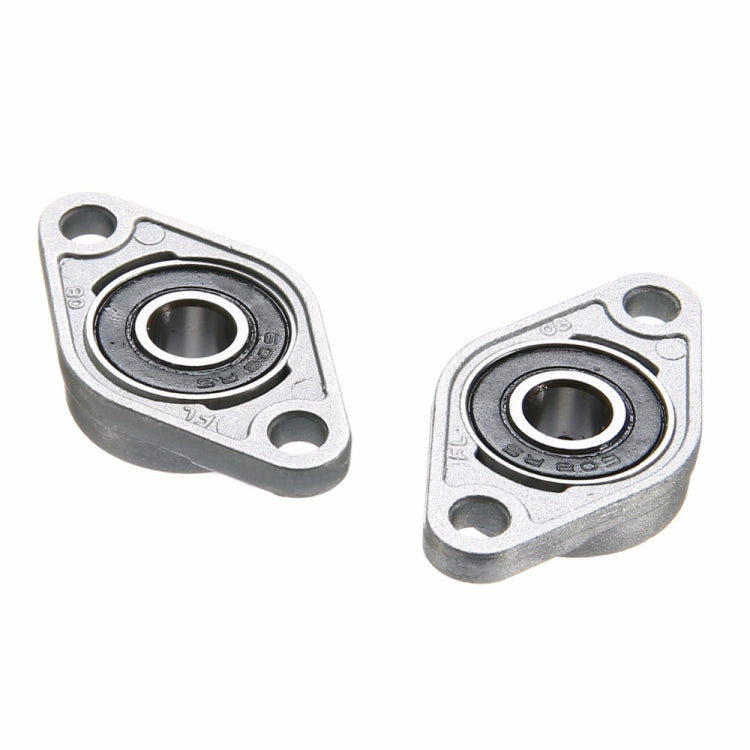 Two zinc alloy bearing housings with black inner bearings, separated view
