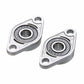 Two zinc alloy bearing housings with black bearing rings, close-up