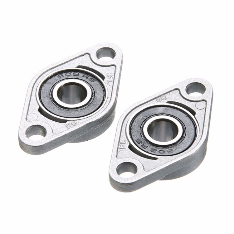 Two zinc alloy bearing housings with black bearing rings, close-up