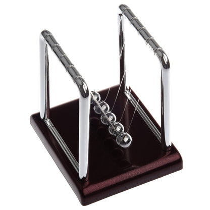 Newton pendulum ball demonstrator with chrome frame, hanging strings, and dark base