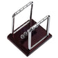 Newton pendulum ball demonstrator with two chrome supports and several hanging steel balls