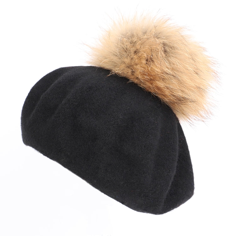 Black plush beanie with tan faux-fur pom-pom