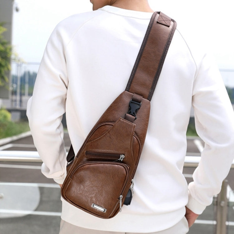 Men's brown single-strap chest bag with front zip pocket and adjustable shoulder strap