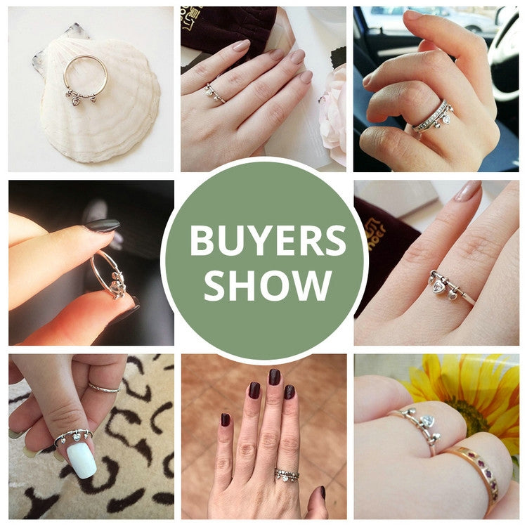 Silver heart charm ring shown on multiple hands in a buyers collage