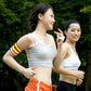 Multicolor glowing LED light armband bracelet worn on an arm over a white tank top