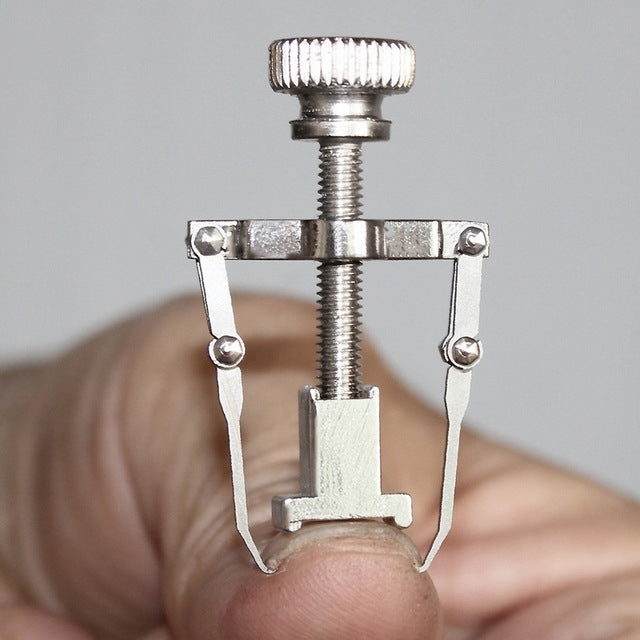 Silver toe nail care clip tool with knurled knob and U-shaped prongs