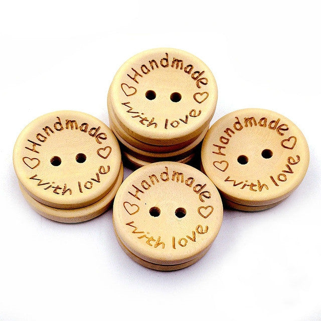 Stack of four natural wood heart buttons with 'Handmade with love' engraving