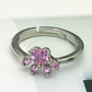 Pink crystal cat-claw adjustable ring on silver-tone open band