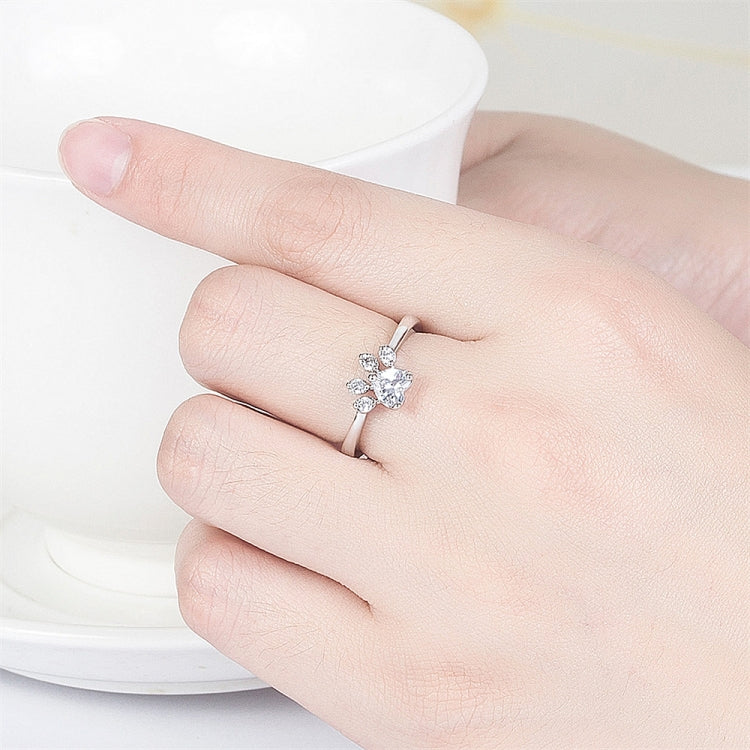 Adjustable cat-claw ring with pink crystals on finger, silver-tone band