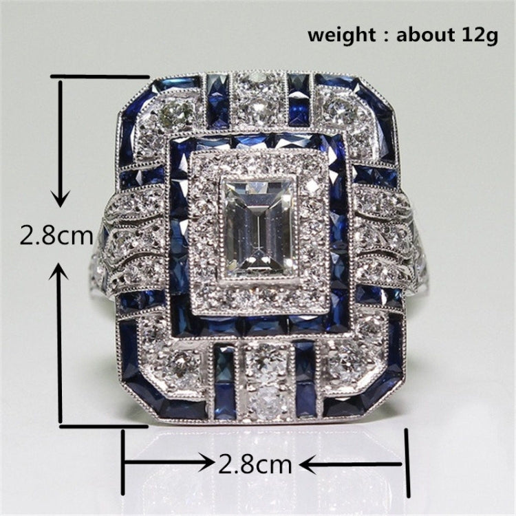 Square-cut crystal halo engagement ring with dark blue accents, center square stone