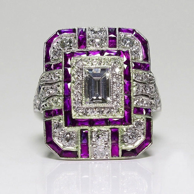 Square-cut crystal halo engagement ring with purple gemstone accents, silver-tone setting