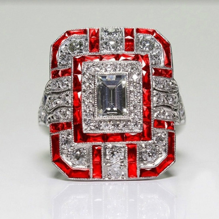 Square-cut crystal zircon engagement ring with clear stones and red halo accents