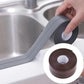 Grey waterproof adhesive sealing tape application, with brown tape roll inset