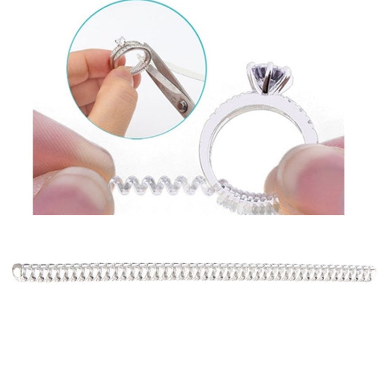 Ring size adjuster spiral tool with metal clip, shown holding a ring