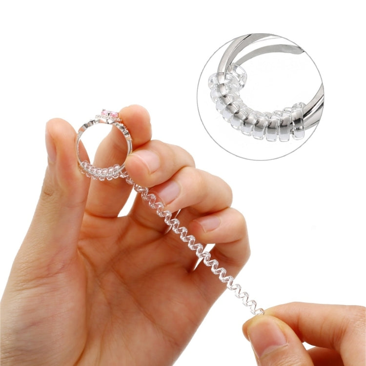 Hand holding a ring size adjuster spiral strip with coiled loops