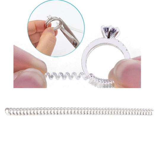 Ring size adjuster spiral tool with metal clip, shown holding a ring