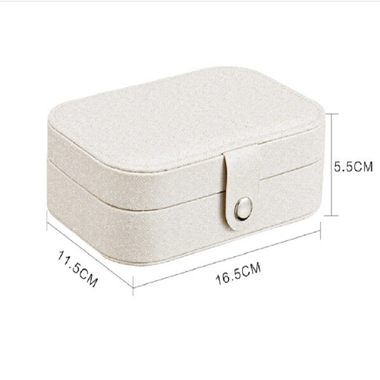 Light beige portable jewelry storage box with size markings and front clasp.