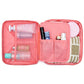 Two-piece coral and pink zippered toiletry bags, one open with mesh compartments.