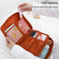 Orange zippered toiletry organizer bag open with mesh section and elastic brush holders.