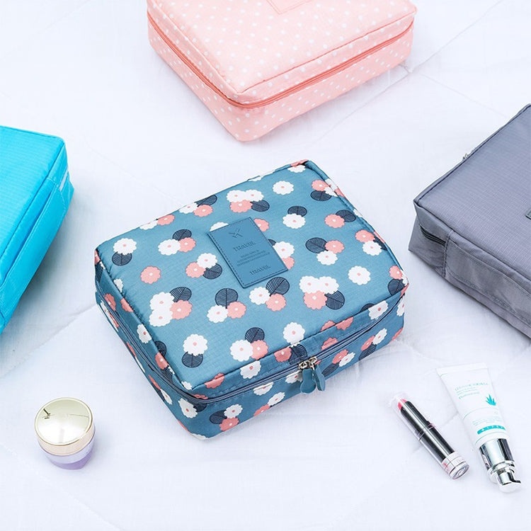 Blue floral zippered toiletry organizer bag with padded rectangular shape.