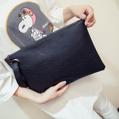Black zippered envelope clutch bag with wrist strap and smooth finish