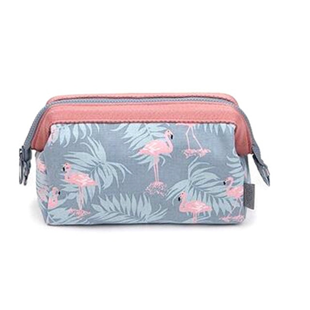 Flamingo print cosmetic bag with pink trim and zippered top, compact travel toiletry case