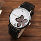 Ladies quartz watch with black leather strap, silver case, white dial with glitter four-leaf clover