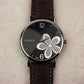 Ladies quartz wristwatch with four-leaf clover dial and black leather-look strap