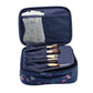 Navy waterproof makeup bag with zip closure, open organizer pockets for cosmetics and brushes.