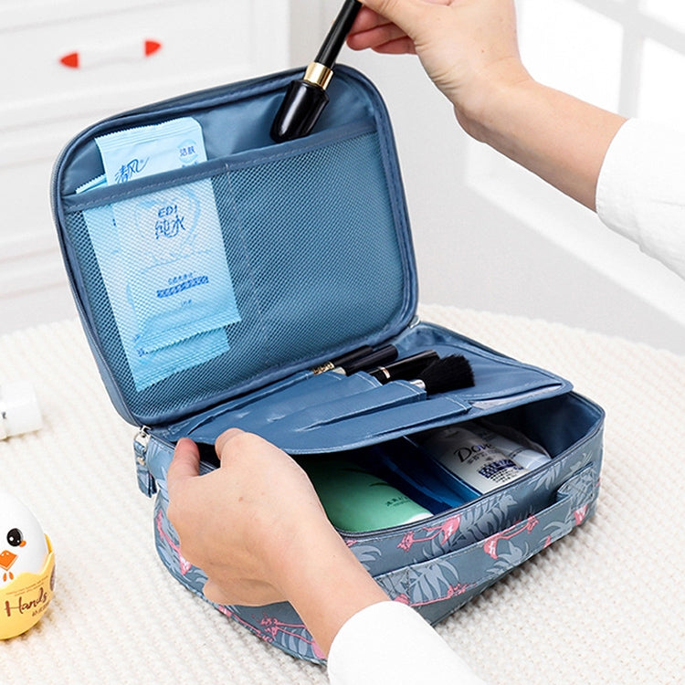 Blue waterproof padded cosmetic bag with zip top, open compartments holding makeup items.
