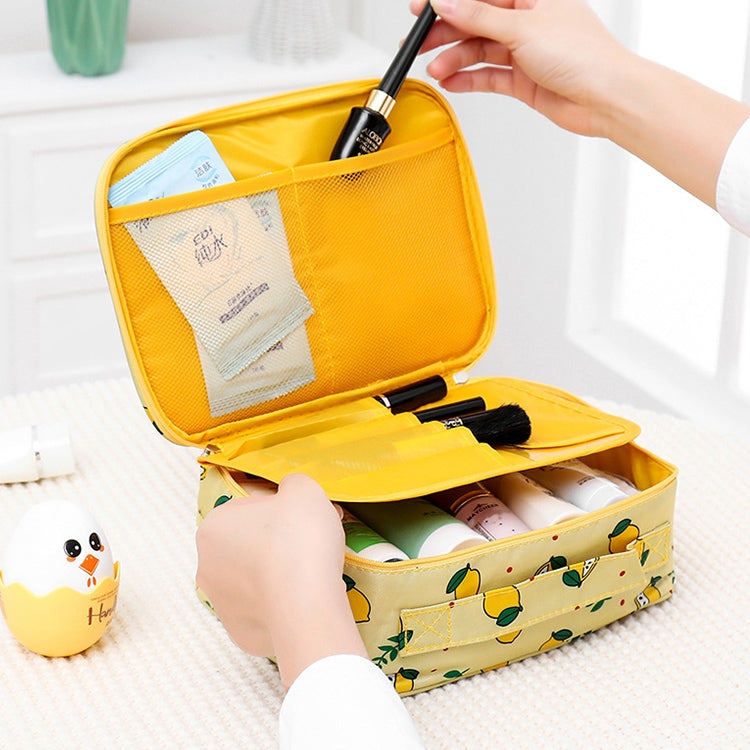 Yellow waterproof padded cosmetic bag with fruit print and zip top, open organizer compartments.