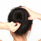 Black donut bun shaper holding a high updo