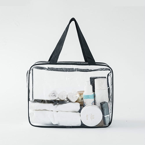Clear PVC travel organizer pouch with black handles and zipper, toiletries inside