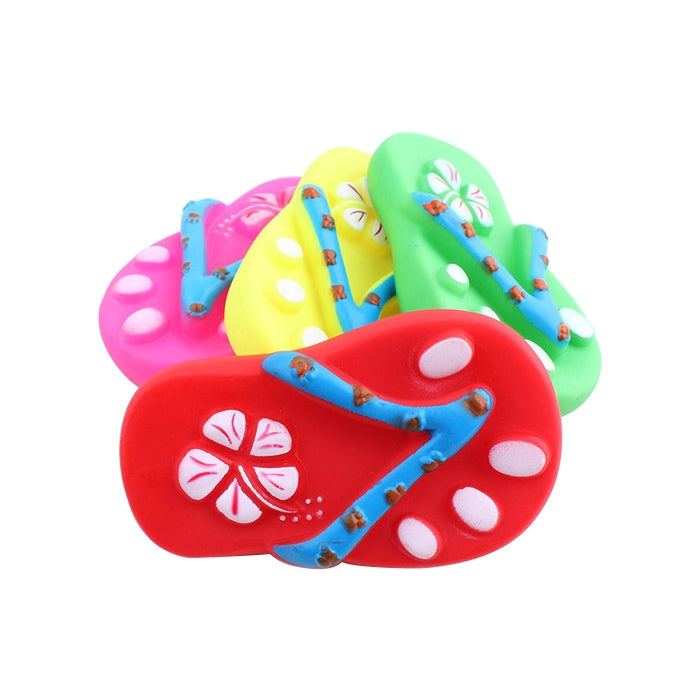 Red rubber squeaky dog chew toy with blue pattern and round white paw accents
