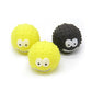 Three rubber squeaky ball toys with cartoon faces, yellow and black spiky texture