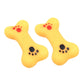 Rubber squeaky dog bone toys in yellow with red and black paw-print designs