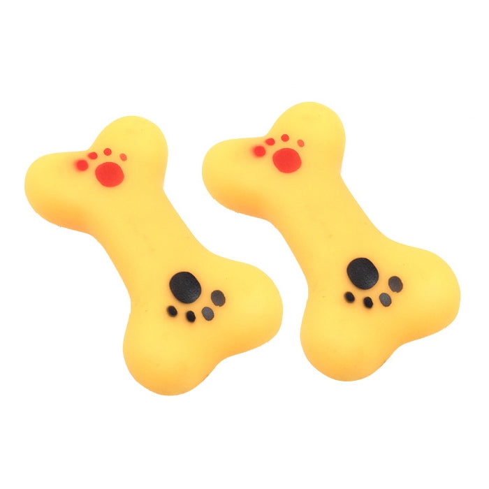 Rubber squeaky dog bone toys in yellow with red and black paw-print designs