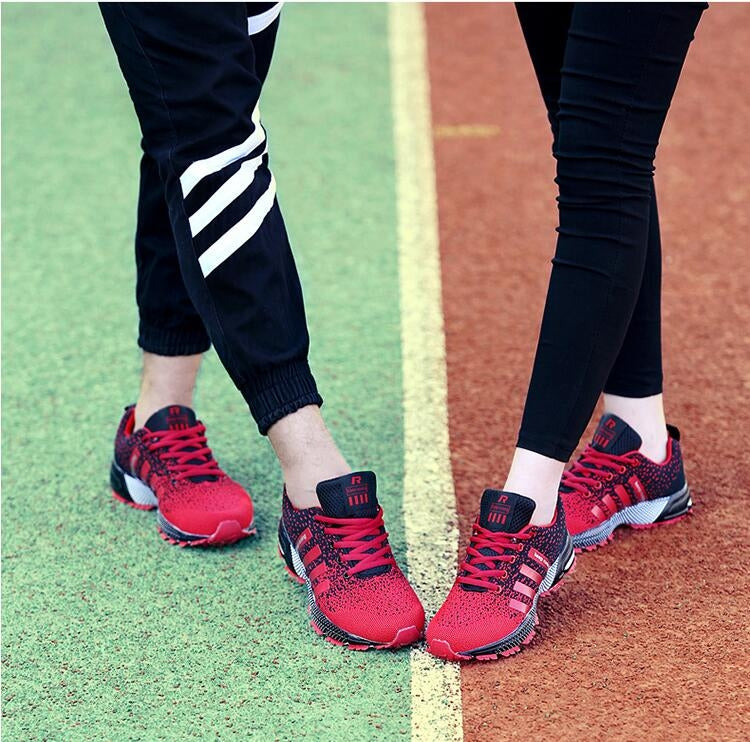 Red trekking sneakers on feet with lace-up design and grippy outdoor sole