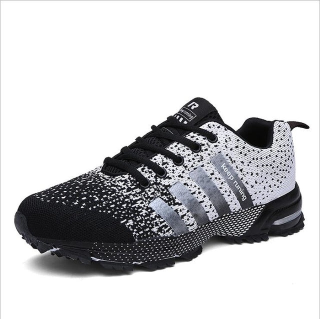 Black and white knit-style trekking sneaker with lace-up closure and rugged tread