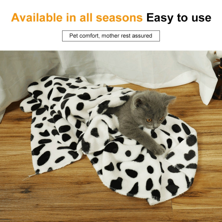 Pet flannel blanket with pastel dot print, draped over pet on floor