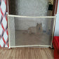 Close-up of portable pet fence gate mesh panel with black base and installed poles
