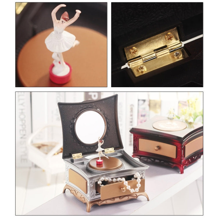 Rotating girl music box with mirror and pearl accents, dark lid over gold rotating disc