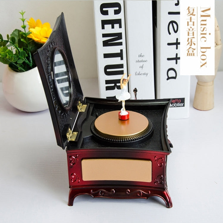 Rotating girl music box with open mirror lid and gold disc, red drawer front
