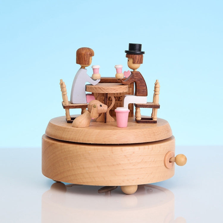 Lover-themed wooden rotating music box with two figures and pink tableware on round base