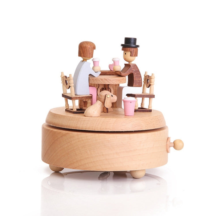 Lover-themed wooden rotating music box, two seated figures at table, pink cups, round base