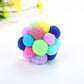 Jewel-tone pom-pom bouncy ball cat toy with green center