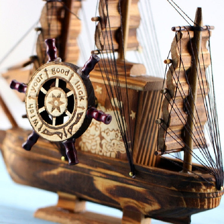 Wooden sailboat ornament close-up of compass wheel with rigging and masts